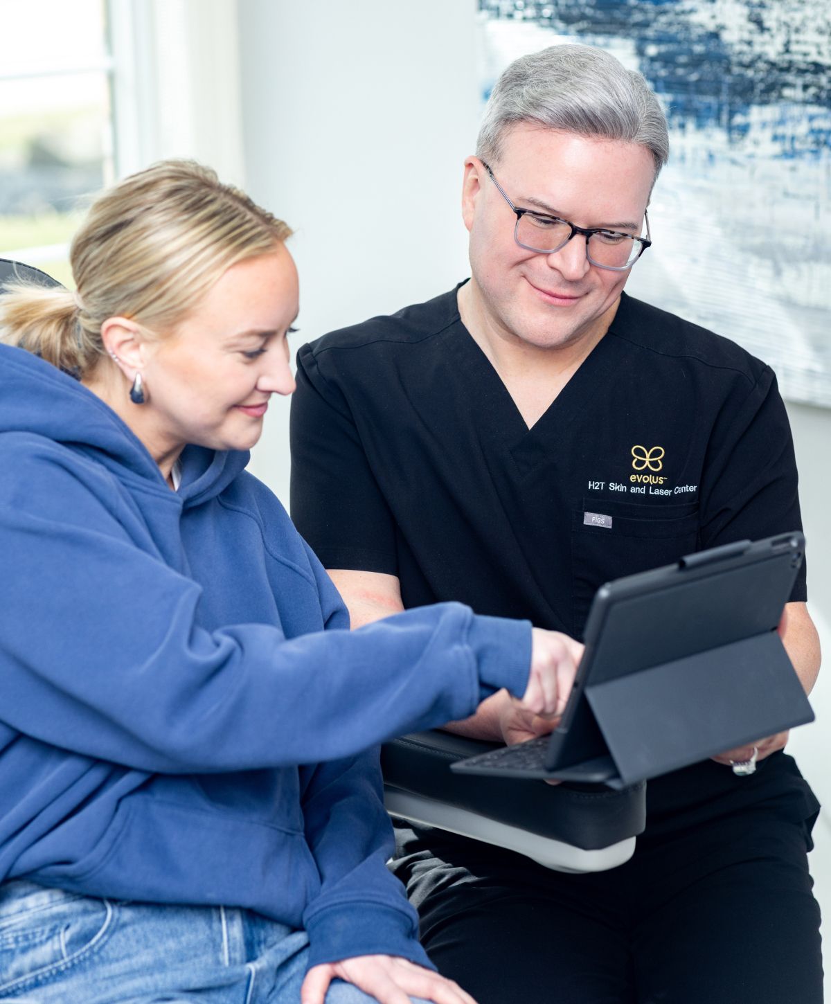 Consultation between doctor and patient using tablet.
