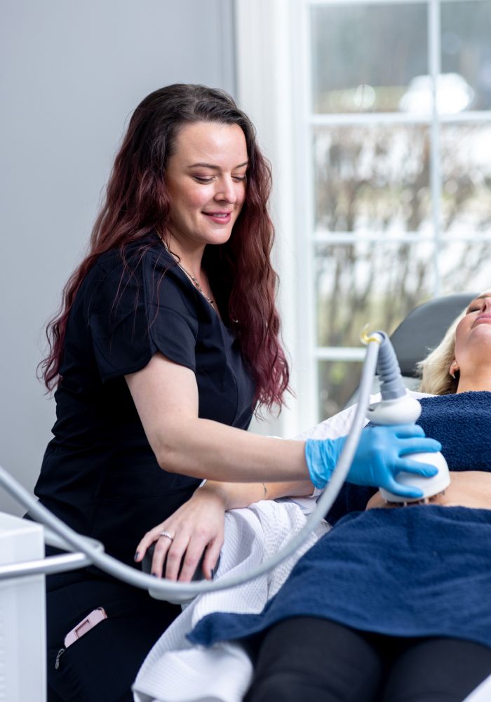 Aesthetic treatment session with client and professional.